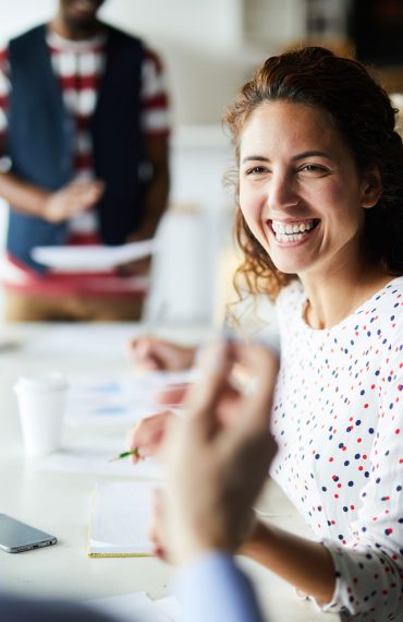 happy-businesswoman-at-meeting-YSNV8BJ.jpg