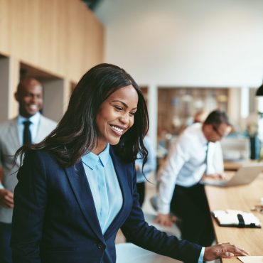 smiling-african-american-businesswoman-sitting-5J3R2YF-scaled.jpg