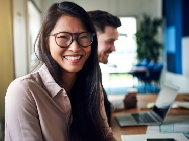 smiling-young-asian-businesswoman-sitting-with-HPT2KJZ.jpg